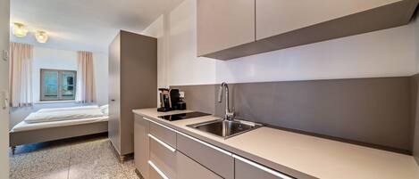 Fridge, stovetop, dishwasher, coffee/tea maker