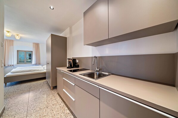 Fridge, stovetop, dishwasher, coffee/tea maker