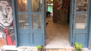 A building entrance with a mural and a blue door. - Royal hotel tanta (Tanta)