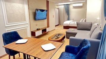 Deluxe Studio Suite | Living area | 32-inch LED TV with satellite channels, TV