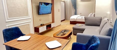 Deluxe Studio Suite | Living area | 32-inch LED TV with satellite channels, TV