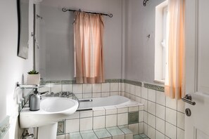 A bathroom with a sink, mirror, and bathtub. - The Hillside Villas, Stunning Views & Private Pool (Corfu)