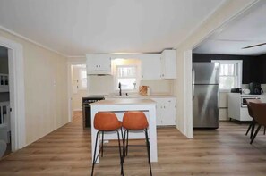 Enjoy cooking in this well-equipped kitchen with a central island and ample counter space.