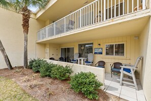A two-story building with a balcony, outdoor seating area, and a sign reading "Sanders Highover 102-104". - Beach-side, beautiful low-rise with uncrowded beach! (Destin)