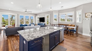 A spacious kitchen with a large island, modern appliances, and ample natural light from large windows. - Beach Escape w/ EV Charger and Pool (Port St. Joe)