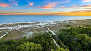 A coastal landscape with a beach, a boardwalk, and dense greenery. - Beach Escape w/ EV Charger and Pool (Port St. Joe)