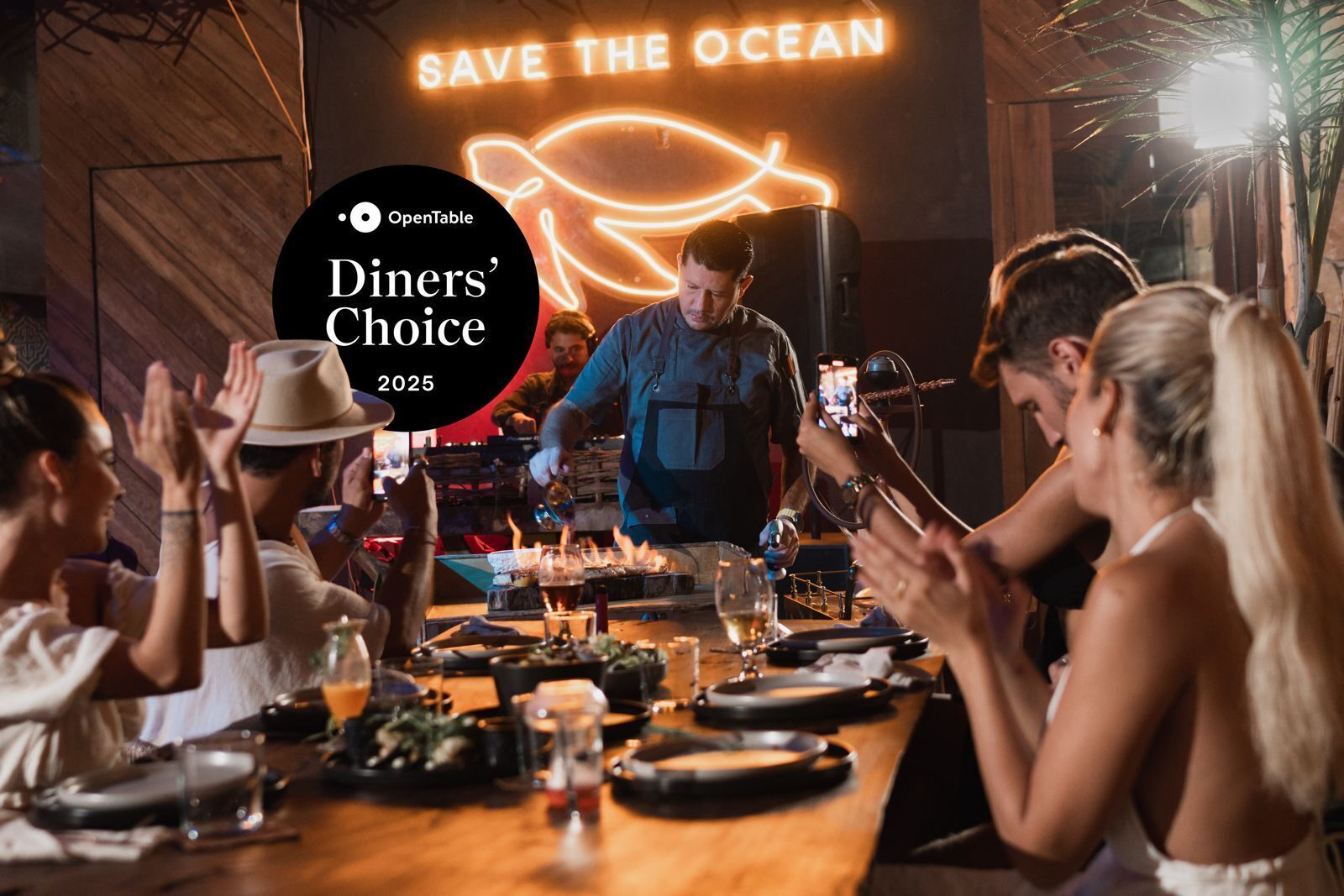 A restaurant with a neon sign reading "SAVE THE OCEAN" and a logo for OpenTable.
