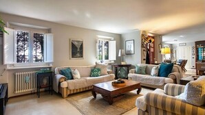 A living room with two sofas, a coffee table, and a radiator.