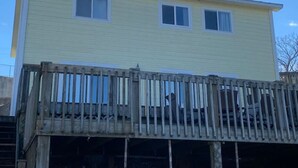 A two-story building with a wooden deck in front. - Lakeshore-Bachelor/Bachelorette Parties welcomed! (Lake Ozark)