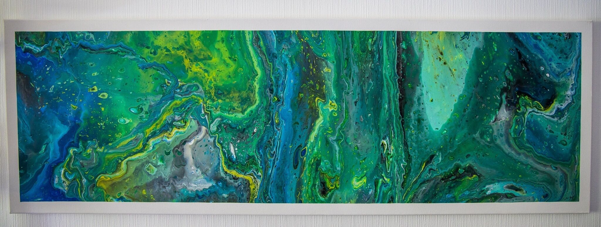Une grande peinture abstraite aux motifs tourbillonnants, dans laquelle se mélangent les couleurs verte, bleue et jaune.