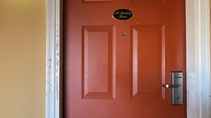 A red door with a sign that reads 'No Smoking Room.' - ATLANTIC INN (Pleasantville)