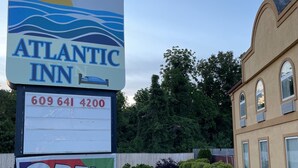 A sign for Atlantic Inn with a contact number and an 'OPEN' sign. - ATLANTIC INN (Pleasantville)