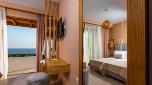 A bedroom with a bed, a TV, and a view of the sea. - Terra Lucis Mountain Residences Mare Villa (Zakynthos)