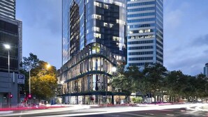 A modern building with a curved facade, large windows, and a parking sign. - Lovely 3BR Apt with Panoramic Views, FREE Parking (Melbourne)
