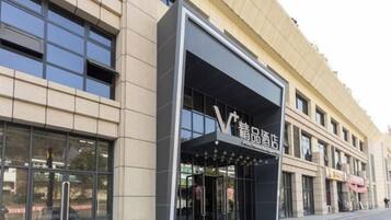 A modern building with a storefront featuring a prominent sign.