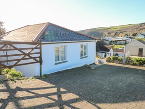 A white house with a tiled roof, a fenced yard, and a paved driveway. - Salakee (Penzance)