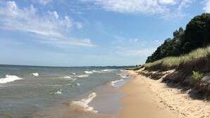 A sandy beach with gentle waves and a clear sky.