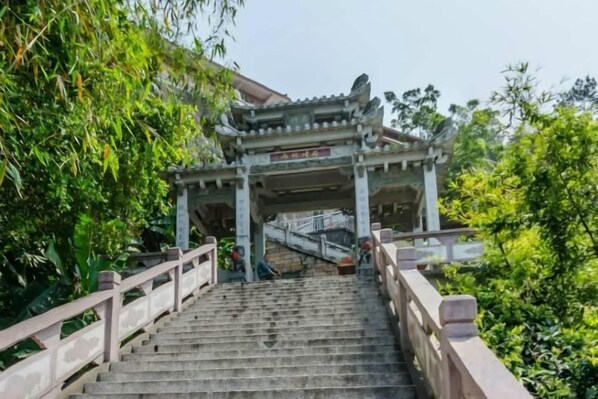 A staircase leading to a traditional Chinese-style pavilion with a roof and railing.