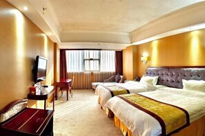 A hotel room with two beds, a desk, a television, and a window with curtains. - Bierga Grand Hotel (Fuqing)
