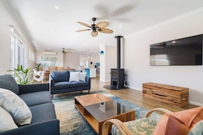 A modern living room with a sofa, coffee table, and a fireplace.