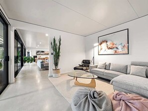 A modern living room with a sofa, coffee table, and a painting on the wall. - Seaview Yallingup (Yallingup)