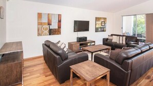 A modern living room with a sofa set, a coffee table, and a flat-screen TV. - Villa on the Cape: Relaxed Hideaway near Town (Dunsborough)