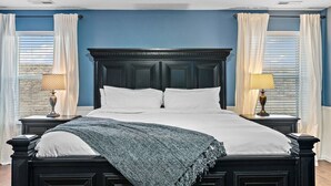 A bedroom with a large bed, white bedding, and two bedside tables with lamps. - The Tangle by Host Boise - 4500sqft Boise Home| 9 Beds & Dual Master| 85" TV (Boise)