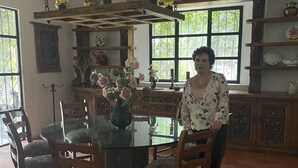 A dining area with a glass table surrounded by wooden chairs, a hanging light fixture above, and a brick ceiling. - Escape to Nature and relax in this marvelous Hacienda Home (EL Marques)