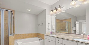 Bathtub, hair dryer, towels, toilet paper