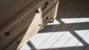 A wooden dresser with drawers and a metal handle.