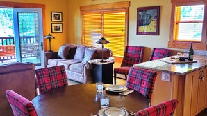 A dining area with a round table set for four, surrounded by plaid chairs. - Kruger Rock Condo #6189 (Estes Park)