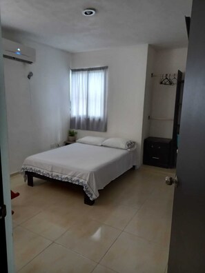 Guests can relax in this cozy space with a single bed, bedside table, and wardrobe.
