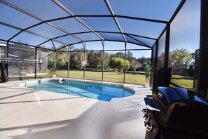 A covered outdoor swimming pool with a view of the surrounding area. - Family Getaway: Game Room, Themed Rooms & Private Yard Near Disney, BBQ!! (Kissimmee)