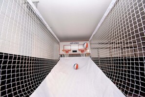 A basketball court with two hoops, a net, and a ball. - Family Getaway: Game Room, Themed Rooms & Private Yard Near Disney, BBQ!! (Kissimmee)