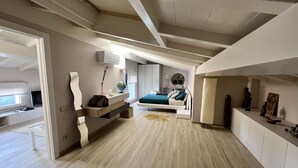 A modern bedroom with a bed, bedside table, and a desk with a globe and a vase. - MODERN DESIGN VILLA OVERLOOKING THE GULF OF MARINA DI CAMPO (Campo nell'Elba)