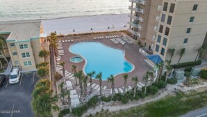 A hotel with a pool area, including a small circular pool and lounge chairs. - Super clean, lower level, recently renovated and beachfront - walk to Pier Park (Panama City Beach)