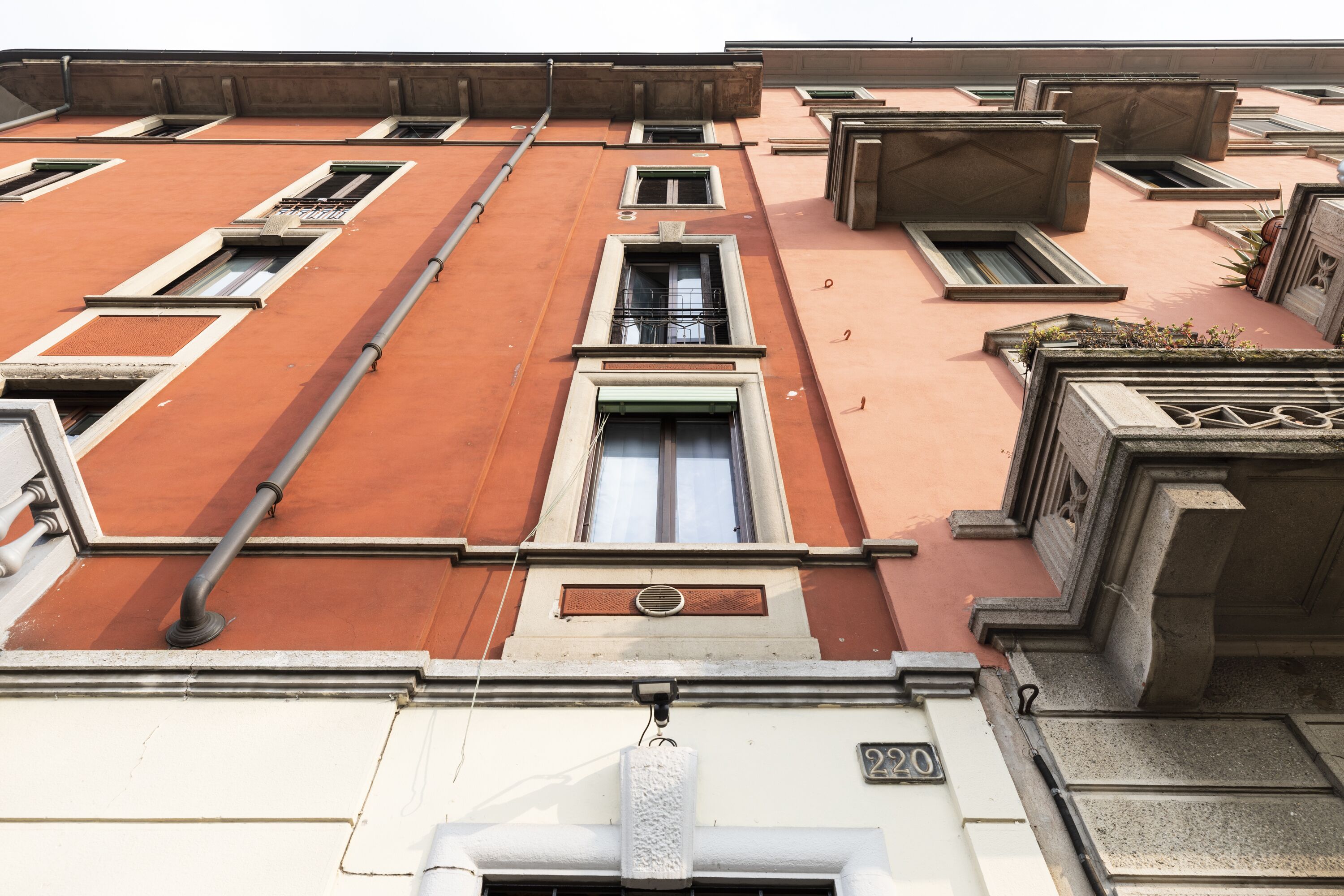 A building facade with multiple windows and a visible address number.