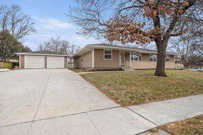 A two-story house with a garage and a front yard.
