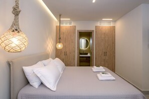 Restful retreat with a large bed, pendant light, and ample storage.