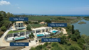 An aerial view of a luxury resort with villas named Villa Emys, Villa Serapias, Villa Waterlily, and Villa Otter.