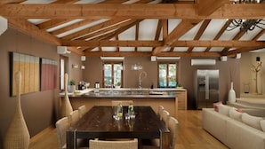 A spacious kitchen with a central island, wooden beams, and a modern stainless steel refrigerator. - Villa Famoso with Pool (Rovinj)