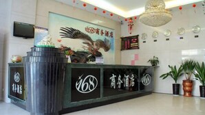 A hotel reception area with a large sign featuring an eagle and the number 168. - 168 Business Hotel (Jinjiang)
