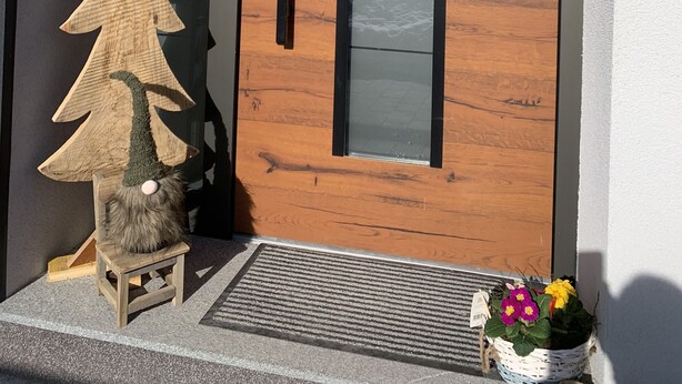 A wooden door with a frosted glass panel and a black handle. - House with wellness near ski slopes (Jesenice)