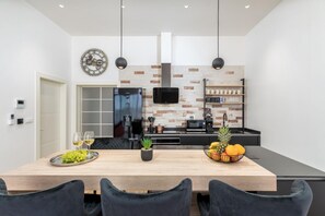 Enjoy cooking and dining in this well-equipped kitchen with an oven, microwave, and coffee machine.
