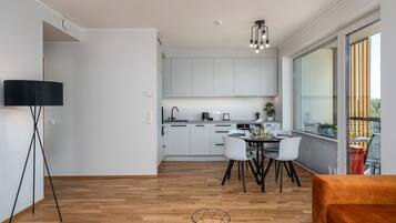 Comfort Apartment | Living area | 55-inch LCD TV with cable channels, TV, Netflix