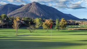 A golf course with a flagstick, trees, and houses in the background. - 2BD/Flagstaff - Full Kitchen, Living Room, W/D and Balcony! (Flagstaff)