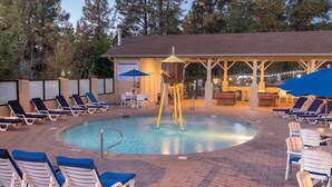 A pool area with lounge chairs, a water feature, and a covered seating area. - 2BD/Flagstaff - Full Kitchen, Living Room, W/D and Balcony! (Flagstaff)