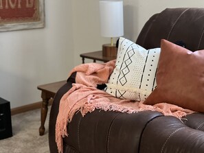 A brown leather sofa with a pink throw blanket and a patterned pillow. - Spacious Higden Retreat <1M from Sugar Loaf Marina (Higden)