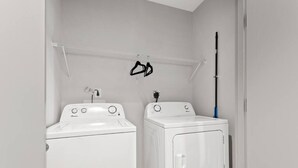 A laundry room with two white washing machines and a drying rack. - 175 LEX - Walkable Downtown Lexington Condo (Lexington)