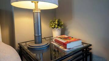 A table with a lamp, a potted plant, and a book titled 'Einstein'.